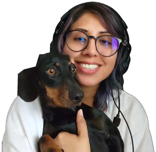 Karem wearing headphones and glasses, smiling and holding Morcilla, her black-and-tan dachshund